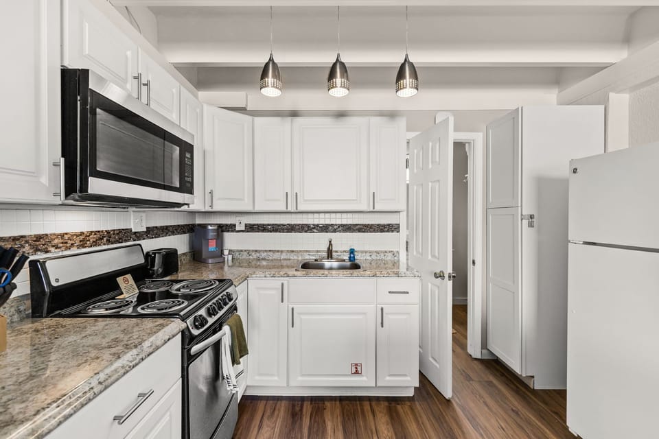 Your fully equipped kitchen features granite countertops, stainless appliances, and bright modern finishes. Everything you need to prepare your favorite meals is right here.