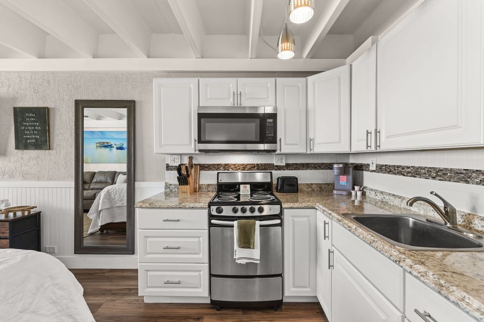 Your fully equipped kitchen makes meal prep easy, with granite counters, modern appliances, and bright white cabinetry to make you feel at home.