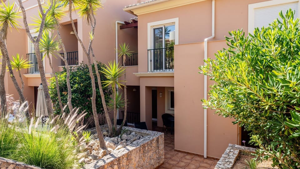 Imagine enjoying your morning coffee on your private patio, surrounded by vibrant Mediterranean foliage, feeling the gentle warmth of the sun. This inviting outdoor space offers a serene escape, perfect for unwinding after a day of exploration.