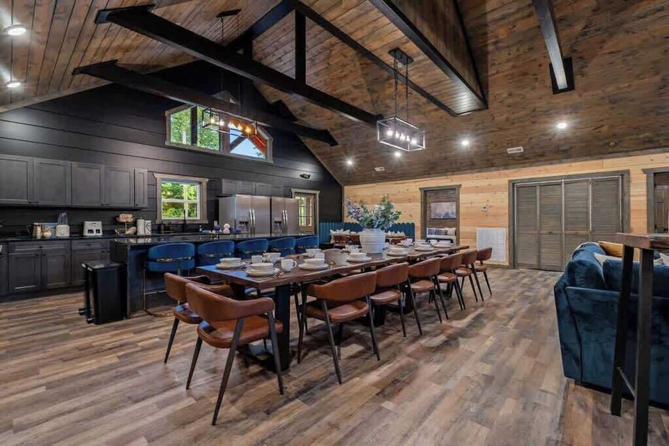 Vaulted lodge-style great room with chef’s kitchen and large dining area