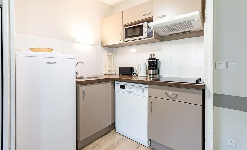 The kitchenette's dishwasher and coffee maker keep the group fed between days at Ax 3 Domaines.