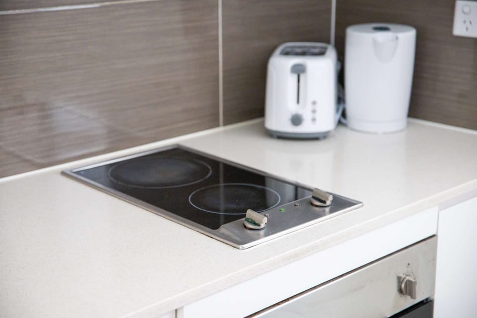Kitchen cooktop with toaster and kettle provided