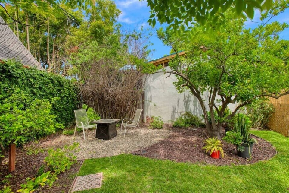 A charming backyard guest house wrapped in greenery, just steps from your own private entrance.
