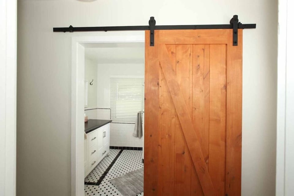 Spa-like finishes and hardwood details make every bathroom feel like a retreat.