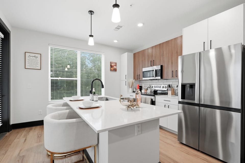 Fully equipped kitchen with stainless-steel appliances and a spacious island. 
