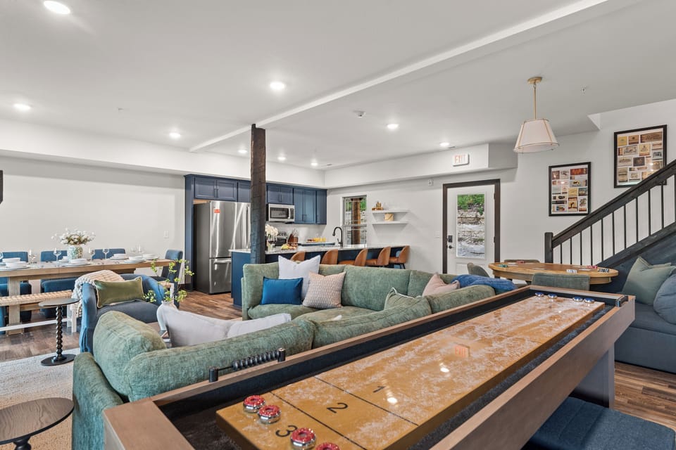 One great room, endless play: shuffleboard, poker table, kitchen, and dining all flow together.