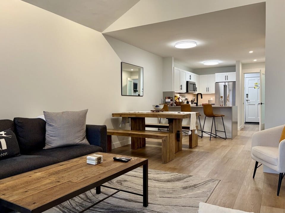 Spacious living area with fireplace, TV, private balcony.