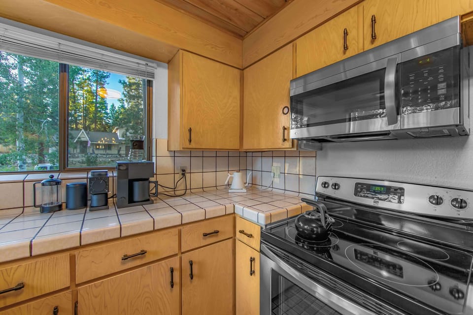 Prepare meals with ease in the fully equipped kitchen, offering ample counter space and everything needed for your Tahoe getaway