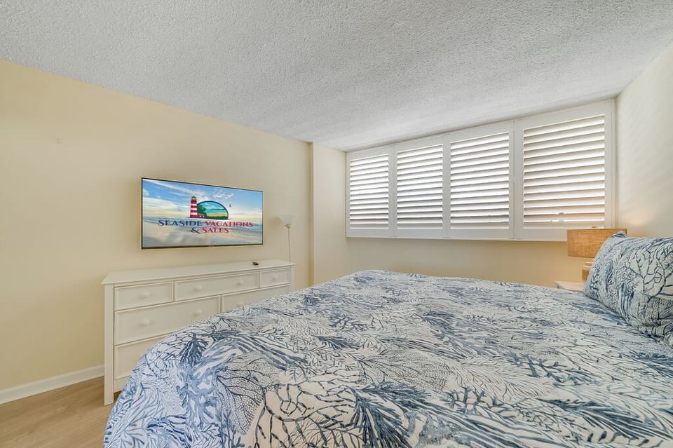 This well-appointed bedroom setup perfectly balances entertainment, style, and relaxation.