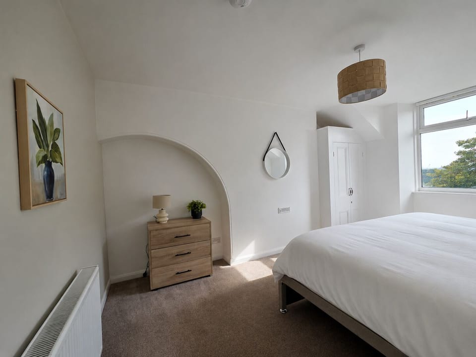 Peaceful double bedroom with comfortable bedding and a bright, airy feel.
