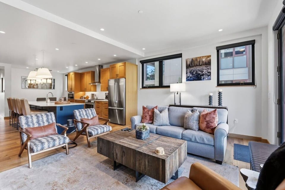 Living room with large windows, fireplace, and smart tv