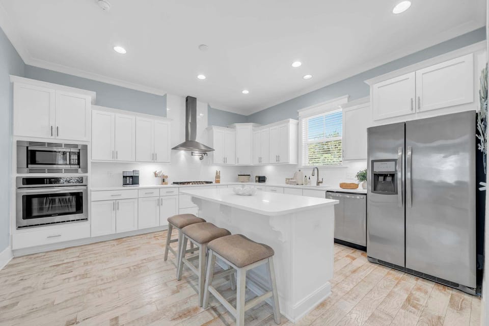 Fully stocked kitchen with additional island seating for 3
