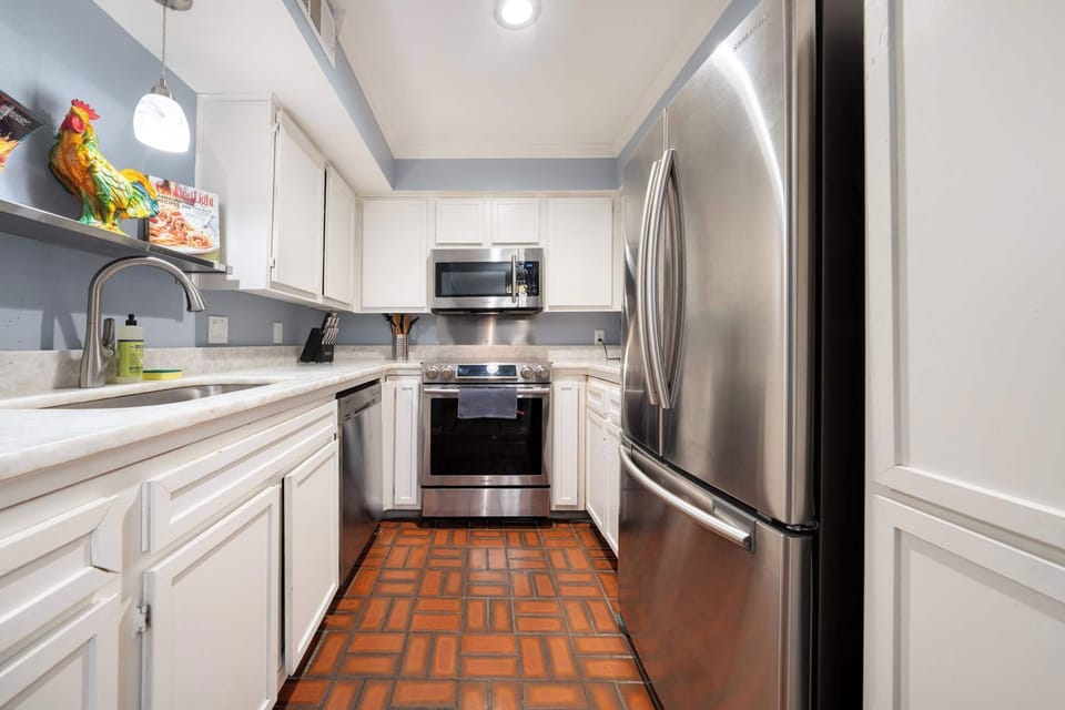 Modern kitchen with stainless steel appliances and charming decor, perfect for culinary adventures.