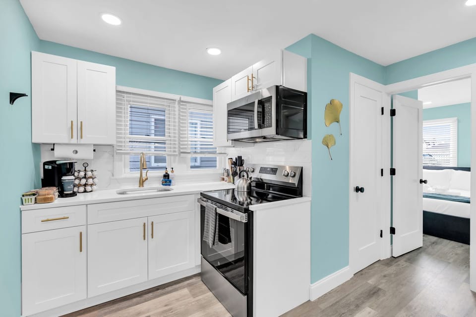 Bright modern kitchen with stainless appliances and cheerful coastal style