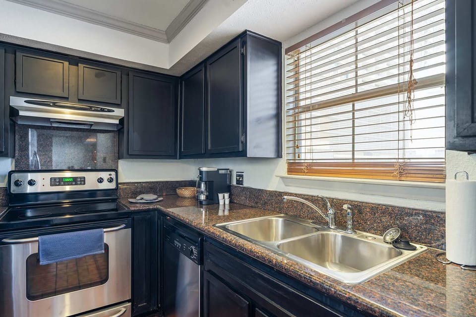 Modern kitchen with sleek appliances and ample natural light, perfect for culinary adventures.