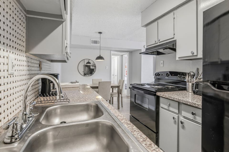 Enjoy cooking in this sleek, modern kitchen with stylish backsplash and ample dining space.