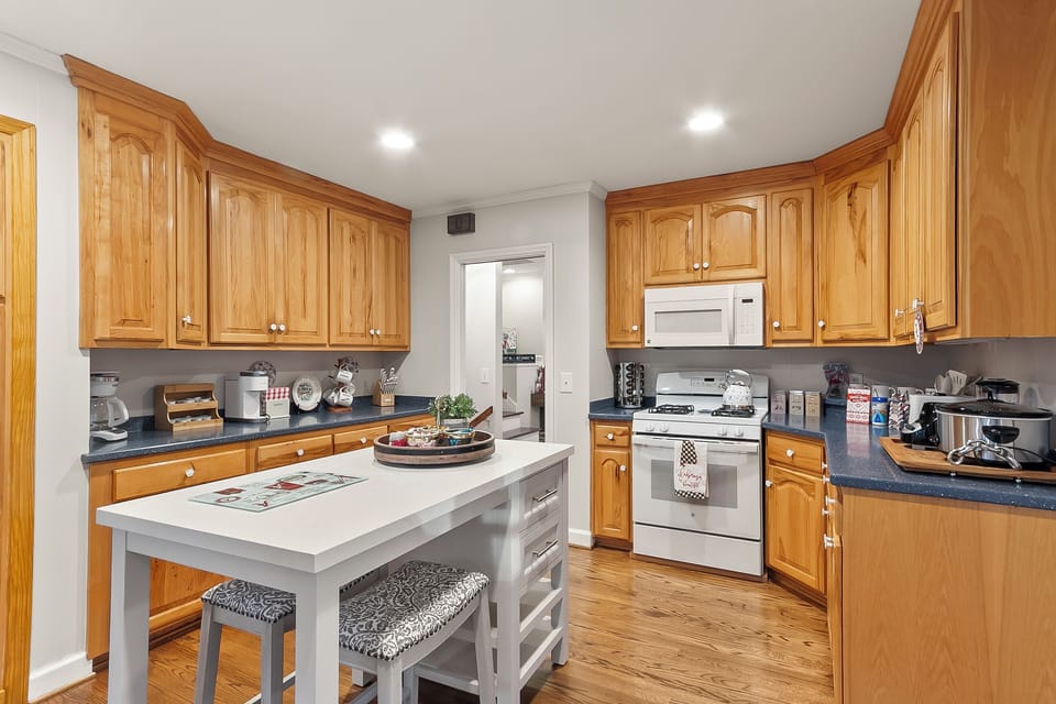 Spacious kitchen with island seating, ample cabinets, and warm wood finishes
