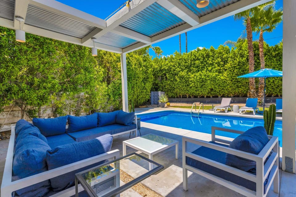 Comfortable covered lounge with a front-row view of the pool