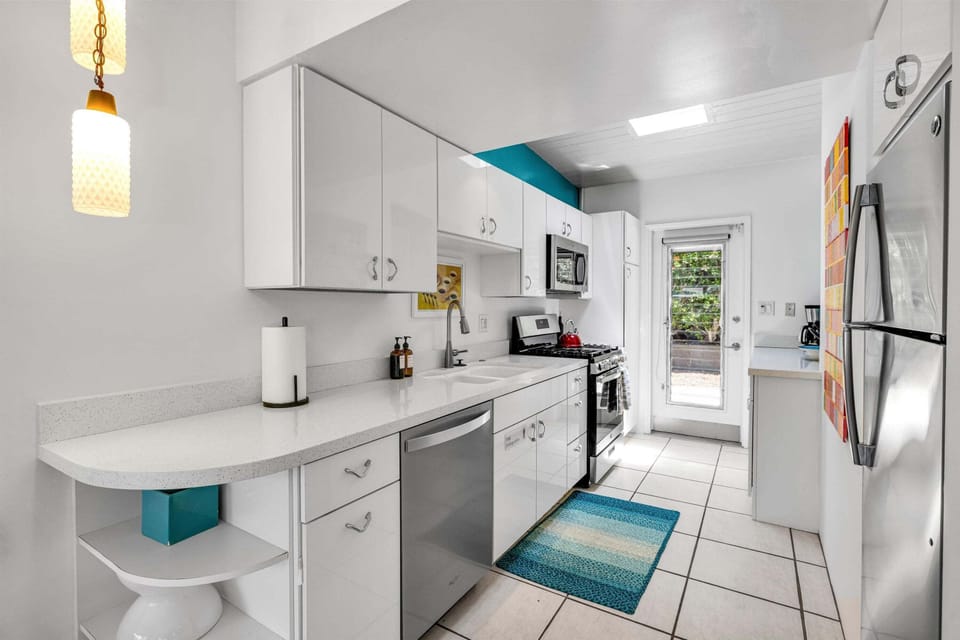 Bright galley kitchen with breakfast bar and full-size appliances