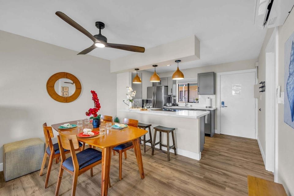 Open dining space with seating for four and a fully equipped kitchen—perfect for home-cooked meals and gathering together.