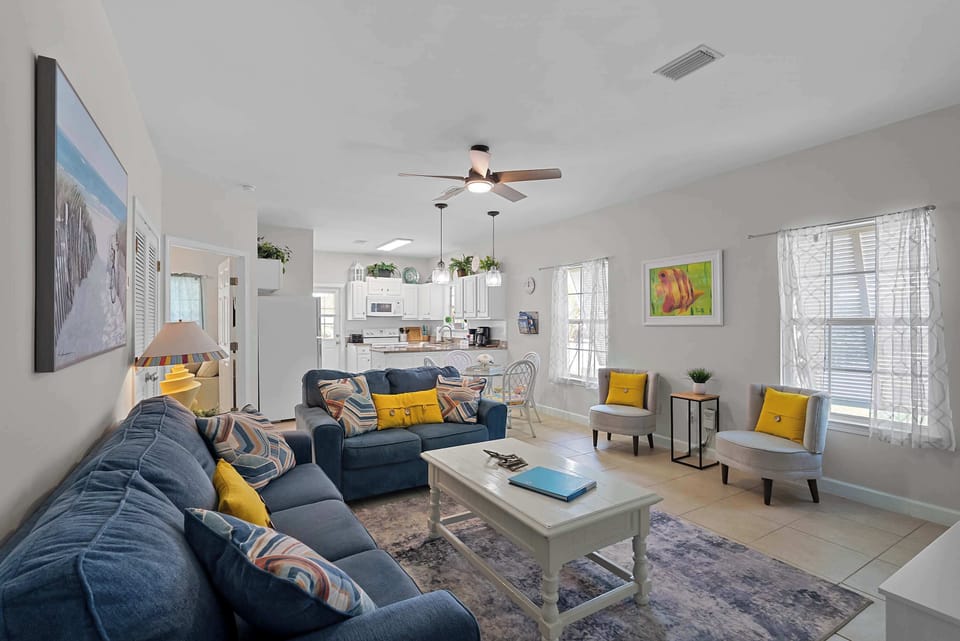 Open living and dining area with abundant natural light and plenty of seating for a group of six.