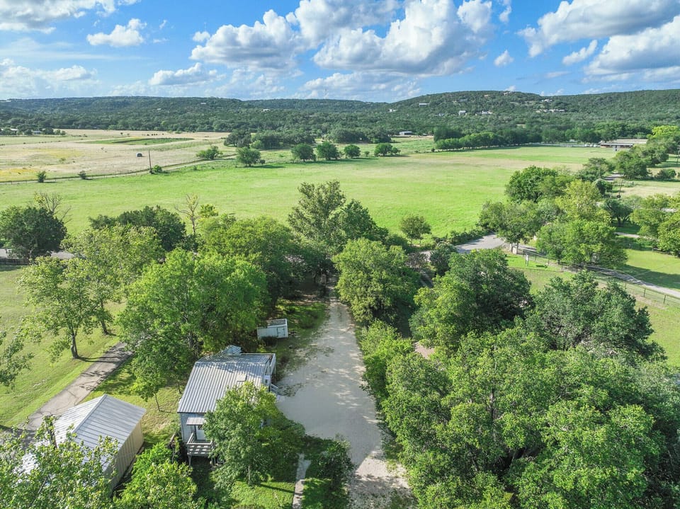 Aerial view of the property nestled among rolling hills.