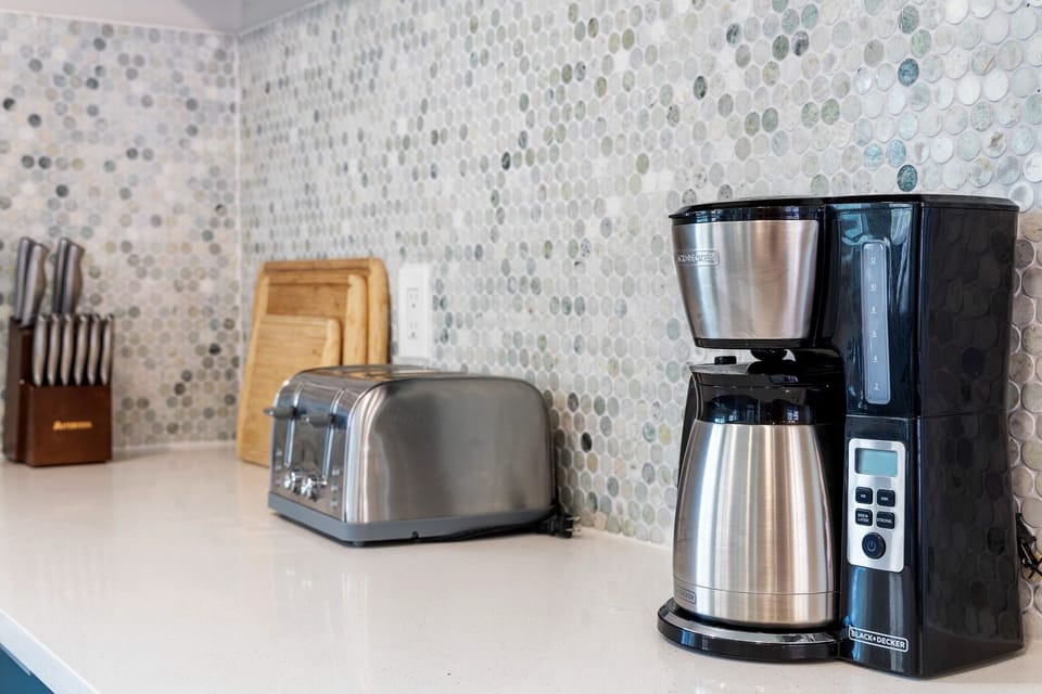 Coffee maker, toaster, and kitchen essentials provided for easy mornings at home.