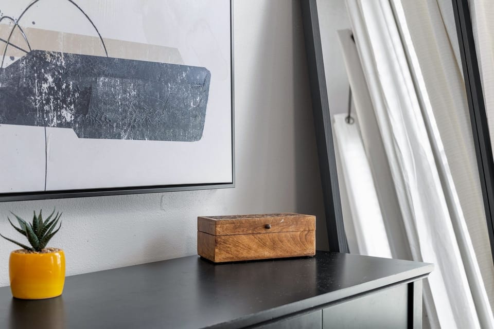 Bedroom detail with dresser storage and simple decor to help guests feel settled during their stay.
