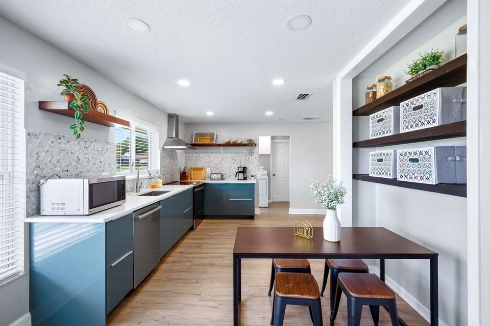 Open kitchen and breakfast bar area, ideal for casual meals, coffee, and gathering throughout the day.