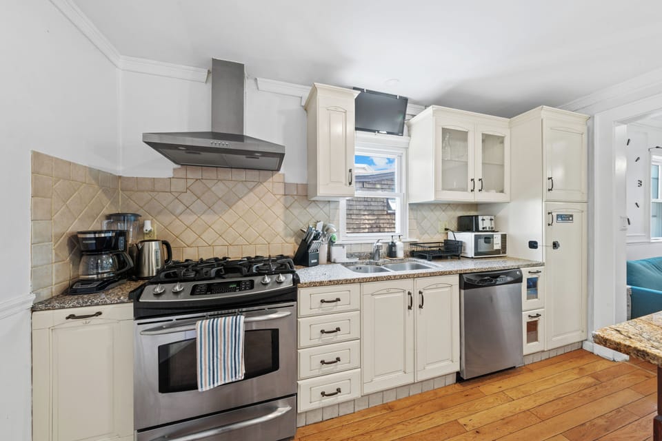 Bright full kitchen with granite counters and stainless appliances