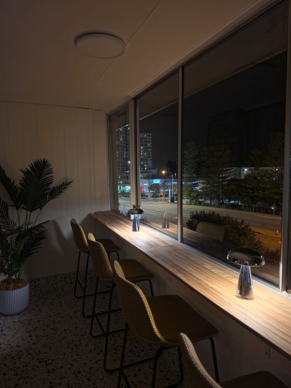 Stylish window-side bar seating with city views and modern ambiance