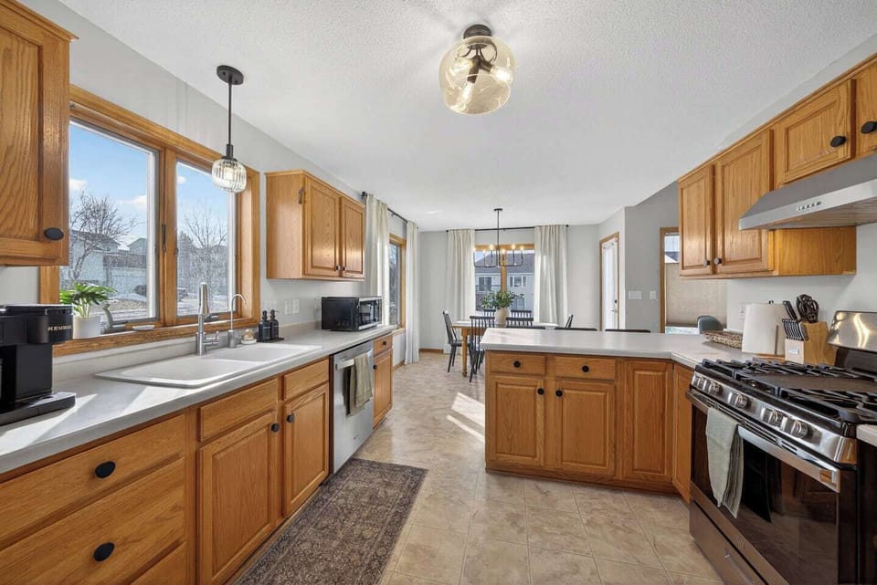 Fully stocked kitchen with lots of natural light and stainless appliances.