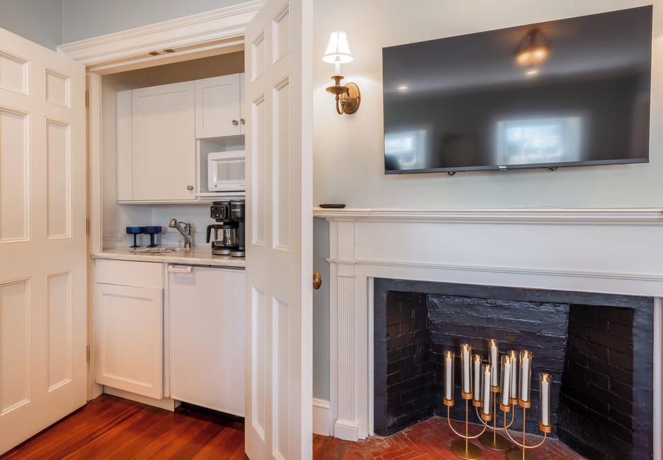 Relax by the fireplace with cozy seating and a flat-screen TV.