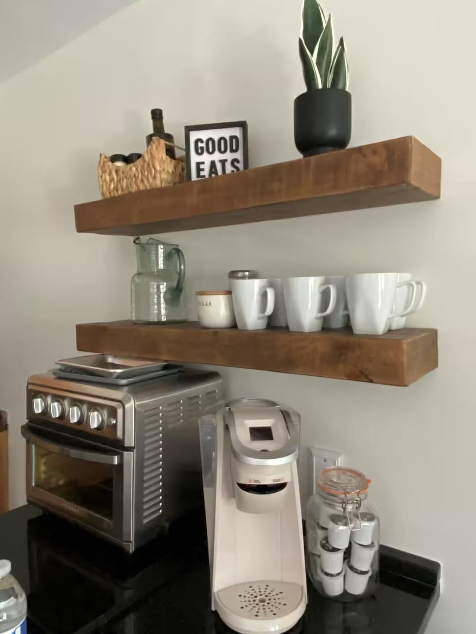 Keurig coffee maker with some k-cups, cream and sugar