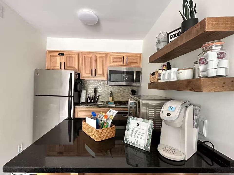 Kitchen is equipped with two-burner electric stove, microwave, extra large air fryer oven, refrigerator and freezer, Brita water pitcher and is fully stocked with plates, cups, utensils, pots/pans, knives, etc. 