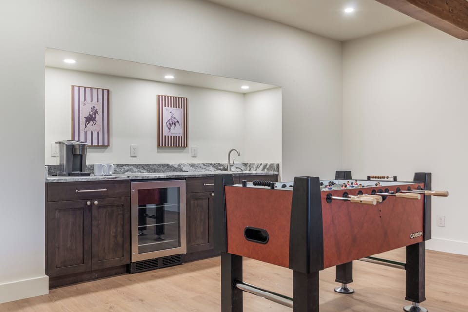 Foosball and coffee / wet bar with additional fridge in downstairs walkout great room space.