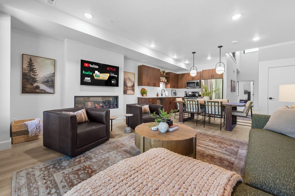 The open-concept living space, complete with a dining area, facilitates effortless conversation with family and friends.