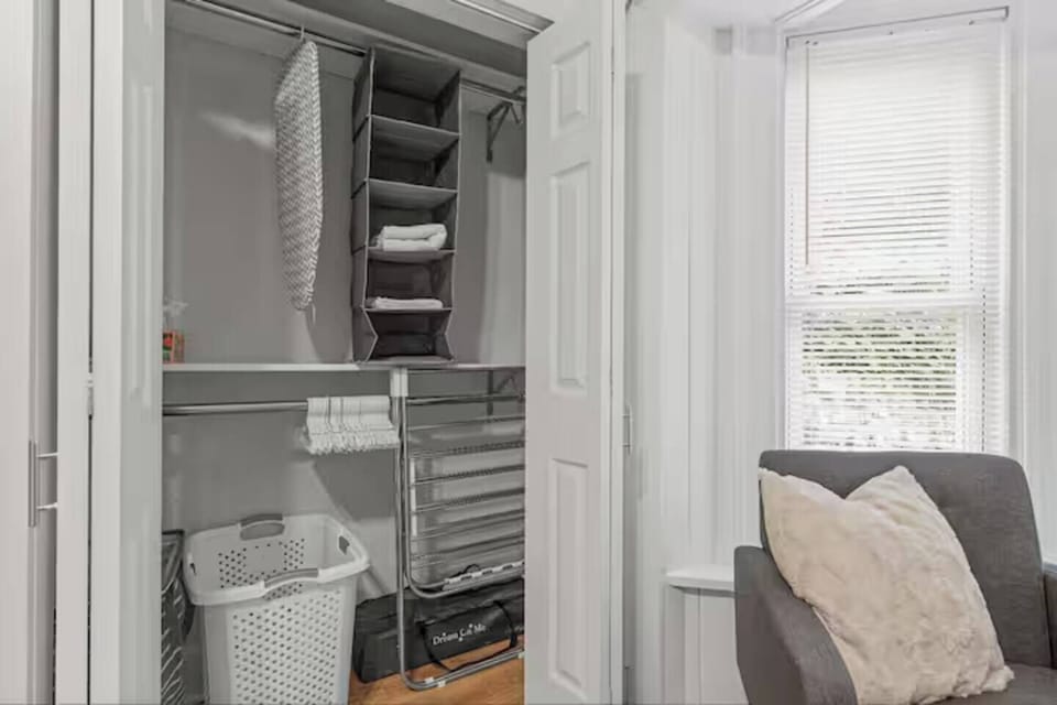 Stay organized with a thoughtfully designed closet featuring ample storage, hangers, and laundry essentials