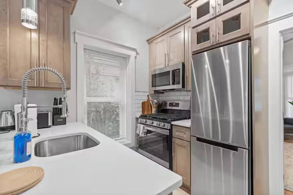 Cook your favorite meals in this bright, modern kitchen featuring stainless steel appliances and everything you need for a comfortable stay.