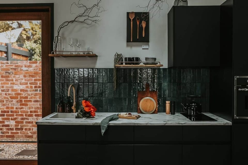 The sleek kitchen, equipped with everything you need, opens directly into your private courtyard. 