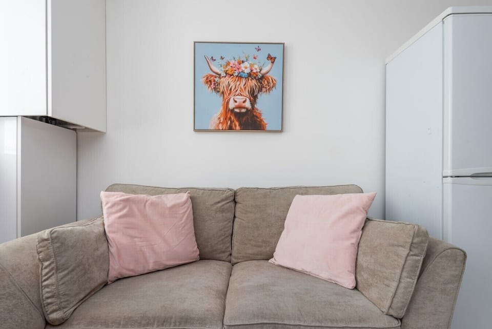 Living Room Sofa with Highland Cow Artwork