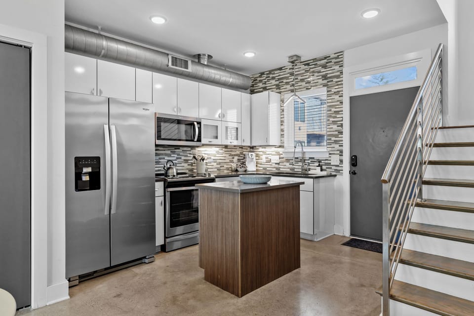 Modern kitchen with ample counters and an island for cooking and gathering.