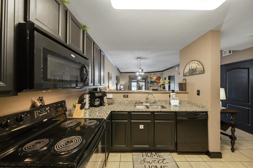 Stylish open kitchen with granite counters and full-size appliances