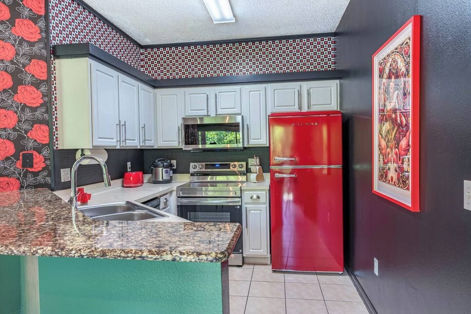 Gather with family and friends in this vibrant kitchen, perfect for cooking, sharing laughs, and creating unforgettable moments together.