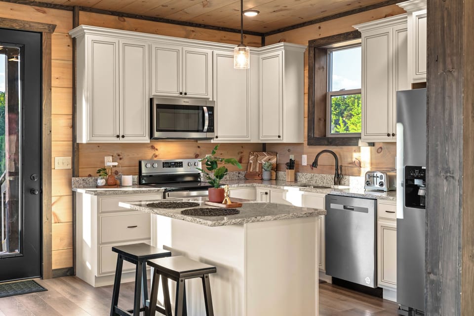 Bright rustic kitchen with island seating and stainless appliances