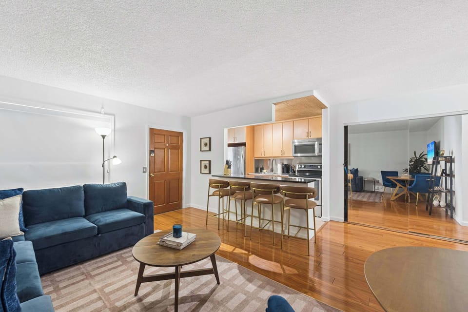 Spacious open-concept living area seamlessly connecting the cozy lounge space to the fully equipped kitchen