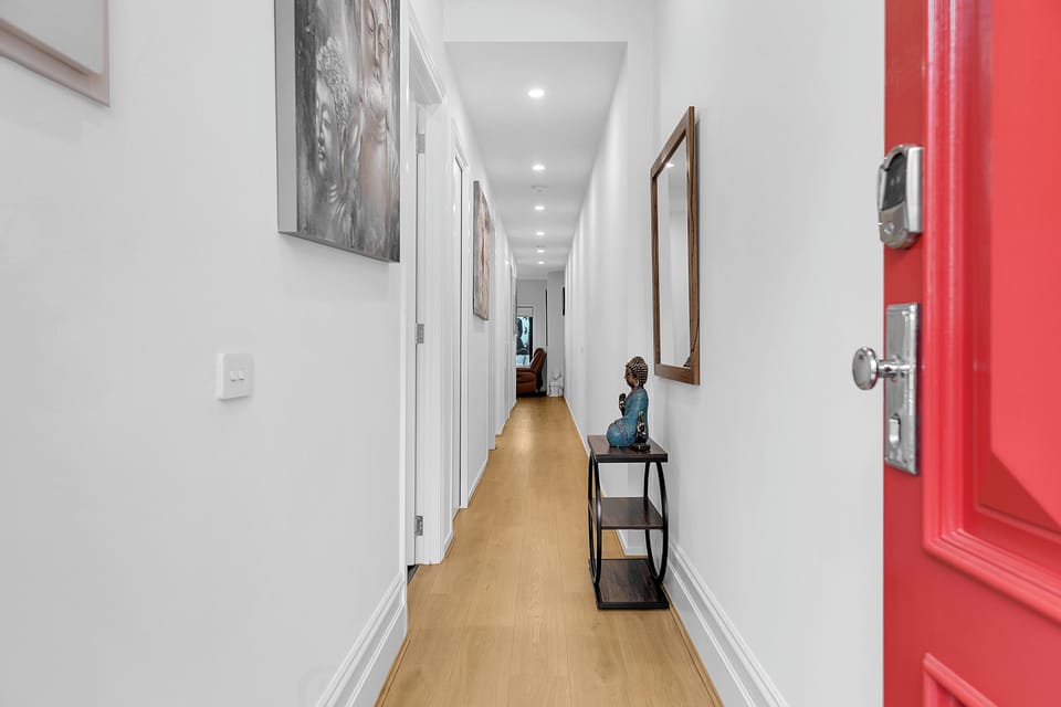 Bright modern entry hall with sleek styling and warm wood floors