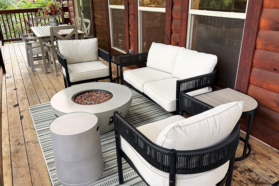 Cozy cabin deck with fire pit lounge and outdoor dining area