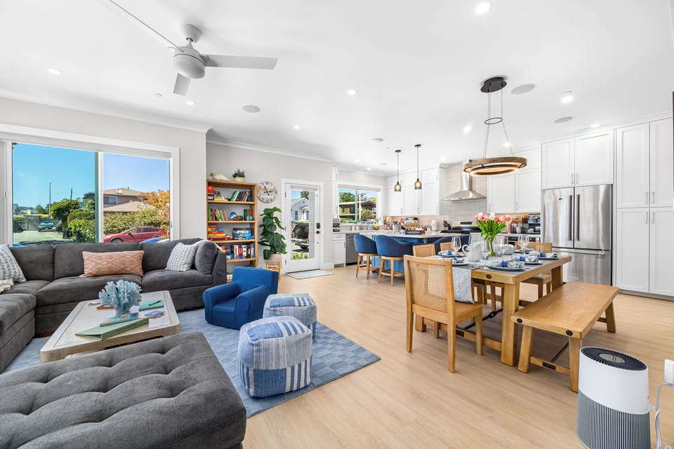 Relaxing living room area with ceiling speakers, TV, and books / games