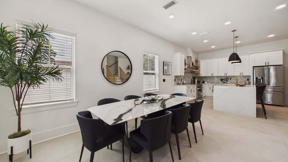 Dining table off from the living area with seating for 8